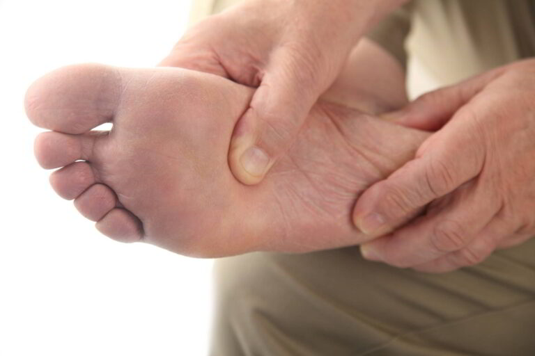 Man holding foot - nerve pain