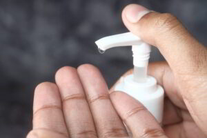 Person pumping gel out of dispenser